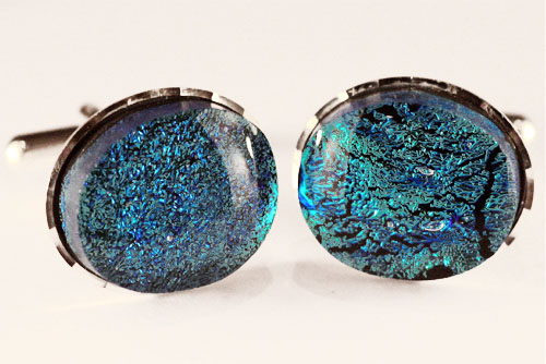 Blue/green irridescent cufflinks set in a diamond-cut mount
